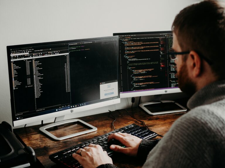 Coding AI PDF tools on dual monitors.